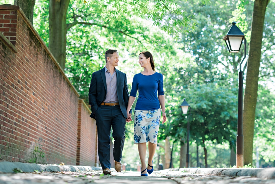 A newly engaged couple walk the cobble stone streets in old city philadelphia.